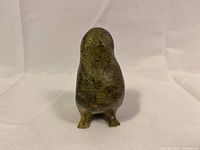 Front view of the vintage Inuit soapstone bird carving on a fabric background.