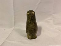 Front view of vintage Inuit soapstone bird carving showing overall shape and color.