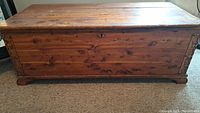 Front view of 1920s cedar hope chest showing the solid wood construction and aged finish.