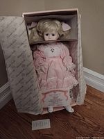 Full view of the Ashton-Drake Meagan doll in original box with certificate of authenticity and a tag visible.