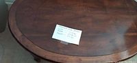 Large oval antique wooden table with note showing dimensions: height 17 inches, length 44 inches.