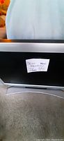 Front view of the 36-inch Magnavox television showing the screen and note attached stating dimensions and 'New'.
