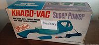 Photo of the Kaco-Vac Super Power hand vacuum box showing the product and included attachments, labeled as 'Brand New'.