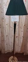 Tall standing lamp with black pleated fabric shade, set against floral curtains with note '60s Vintage Lamp'