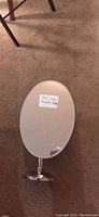 Oval mirror with stand labeled '18x24 Oval Tempered Mirror'