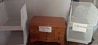 Photo of MedJewel jewelry box and white metal basket organizer with handwritten labels.