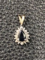 Front view showing pear-shaped sapphire and diamond halo