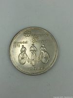 Obverse side showing three cyclists, Olympic rings, and inscriptions including 'Montreal 1976', 'Olympiade XXI Olympiad', and '10 Dollars'.