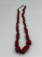 Full view of the Mediterranean coral bead necklace showing red irregular beads and silver clasp.