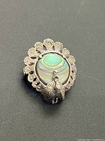 Front angle showing intricate silver peacock and mother of pearl inlay