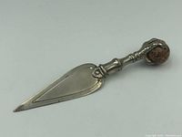 Front view of sterling silver claw bookmark with stone, showing blade and claw detail.