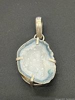 Front view of the natural geode pendant set in sterling silver showing crystalline details inside the stone.