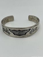 Front view of the sterling silver bracelet showing engraved Harley-Davidson Motor Cycles logo and motorcycles on either side