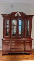 Front view of the American DRFW buffet and hutch showing wood finish, brass hardware, drawers and glass doors.