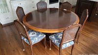 Table and all eight chairs arranged in kitchen space, overhead angle