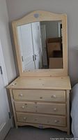 Front view of large dresser with mirror showing shape, knobs and finish