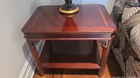 Front view of one side table showing top surface inlaid border and lamp placeholder