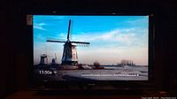 Samsung 52-inch flat-screen TV powered on, displaying clear image of windmills.