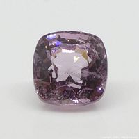 Close-up image showing the top face and facets of the square cushion cut pink Spinel gemstone with natural inclusions visible inside.
