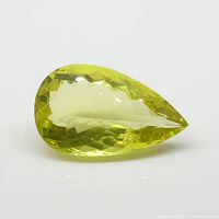 Top and side angle views of the pear shape lemon citrine gemstone showing faceting and yellow color.