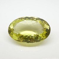 Close-up top view of the large oval lemon citrine gemstone with visible faceting.