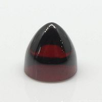 Close-up front angle showing the bullet-shaped polished garnet gemstone with a deep, glossy red color and smooth facets.