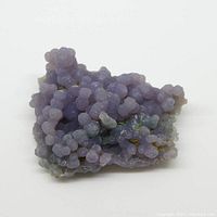 Front angled view of purple grape amethyst gemstone specimen showing botryoidal crystalline clusters and uneven freeform shape.