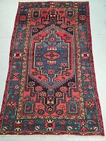Full view of rug showing overall geometric medallion pattern and border details
