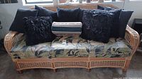 Front view of bamboo rattan sofa with seat cushion and six pillows
