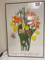 Full view of the framed floral print showing large bouquet of colorful flowers and frame.