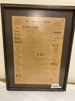 Framed The Industrial Banner newspaper shown fully in image with brown frame