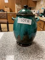 Front view of the large Blue Mountain Pottery covered jar with lid and two loop handles, showing green and blue drip glaze finish.