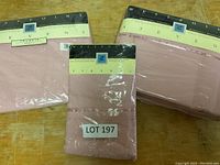 Three individually packaged queen size sheets and pillowcases in pink color, labeled with brand Westpoint Stevens and generation TrueFit.