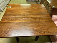 Top view of rectangular oak dining table showing wood grain finish.