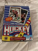 Front view of 1991-92 O-Pee-Chee hockey wax box with player images and promotional text