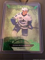 Front side of 2020 Upper Deck Artifacts Elias Pettersson hockey card numbered 35/99 showing player image and design.