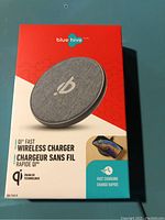 Photo of the Blue Hive QI Fast Wireless Charger packaging showing the product image, branding, and features such as QI fast wireless charging and fast charge capability.