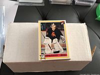 Close-up of Greg Dreveny OHL hockey trading card on a white box