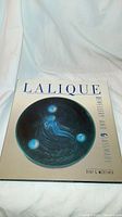 Front cover of Lalique Jewelry and Glassware book with blue circular artwork