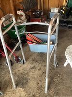 Full view of wheeled adjustable height walker and background with other medical aids