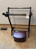 Side view of solid wood quilt rack showing colonial turned legs and horizontal bars for hanging quilts.