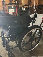 Rear view showing foam-padded backrest and rear mag-style wheels