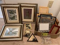 Overview of the three main framed art prints and box of additional small framed pictures and empty frames