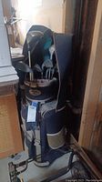 Full view of the Wilson golf bag loaded with clubs placed upright indoors