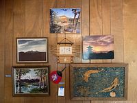 View of all wall art pieces including framed photos, textile art, fan, and hanging woven decoration