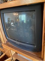 Front and angled view of the Sharp CRT television showing screen, control panel, and curved CRT tube.