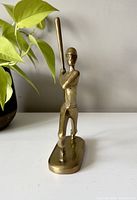Front view of brass baseball player figurine showing batting stance and detailing.