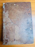 Front cover of one volume showing heavy wear and surface marks