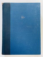 Front cover of the blue hardcover book with some surface wear.