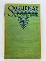 Front cover of the hardcover book titled 'Saguenay' by Blodwen Davies, showing the green cloth cover with blue lettering and emblem.